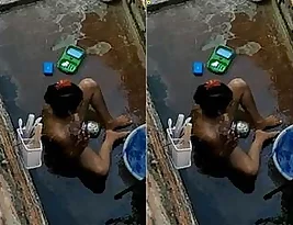 Pretty Indian woman takes a bath outdoors