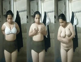 Beautiful big-breasted Indian woman showing off her curves in the bathroom.