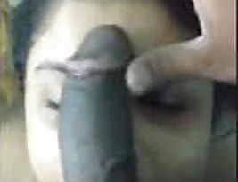 A beautiful mature woman gives her best and stares intensely while giving a blowjob to a big black cock