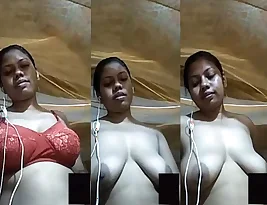 Hot village beauty shows off her large breasts in a selfie video.