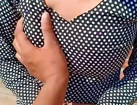 A wife’s breasts are fondled and penetrated by her husband from the back in a steamy encounter.