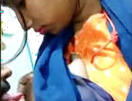 Married Indian woman breastfeeds and kisses her husband