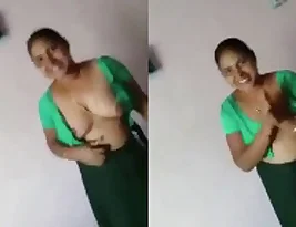 An elderly Indian woman seduces her customer and exposes her big breasts.