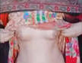 Young female wearing a headscarf exposes her breasts and unshaven genitals.