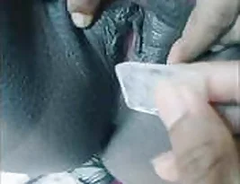 Beautiful Indian woman with a perfect body puts ice in her breast.