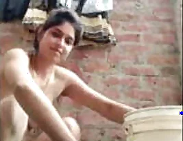 A villa mother-in-law is washing her breasts while taking a bath.